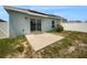 Newly built home featuring a concrete patio and solar panels at 6931 Wilson Pasture Ave, Groveland, FL 34736
