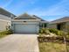 Two car garage and front yard at 6931 Wilson Pasture Ave, Groveland, FL 34736