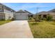 Two car garage and front yard at 6931 Wilson Pasture Ave, Groveland, FL 34736
