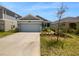 Two car garage and front yard at 6931 Wilson Pasture Ave, Groveland, FL 34736
