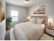 Cozy bedroom with carpeted floors, neutral walls, and ample light at 6931 Wilson Pasture Ave, Groveland, FL 34736