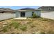 Home with backyard, concrete patio, and solar panels at 6931 Wilson Pasture Ave, Groveland, FL 34736