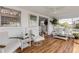 Relaxing sunroom with hardwood floors, comfortable seating and large windows at 1232 Bel Aire Dr, Daytona Beach, FL 32118