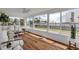 Spacious sunroom with hardwood floors, white furniture, and natural light at 1232 Bel Aire Dr, Daytona Beach, FL 32118