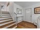 Bright entryway with hardwood floors, stairs, and a modern console table at 1232 Bel Aire Dr, Daytona Beach, FL 32118