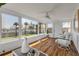 Bright sunroom featuring hardwood floors, white furniture and backyard views at 1232 Bel Aire Dr, Daytona Beach, FL 32118
