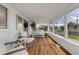 Sunroom with hardwood floors, white furniture, and backyard views at 1232 Bel Aire Dr, Daytona Beach, FL 32118