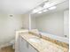 Bathroom boasts granite countertop, white cabinets, and a large mirror at 201 Tranquility Cv, Altamonte Springs, FL 32701