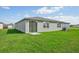 House exterior showcasing a well-maintained lawn and sliding glass door at 1717 Forest Run Ln, Auburndale, FL 33823