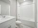 Clean bathroom with white vanity, bathtub, and tiled flooring at 1717 Forest Run Ln, Auburndale, FL 33823