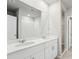 Double vanity bathroom with white cabinets and a large mirror at 1717 Forest Run Ln, Auburndale, FL 33823