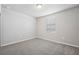 Bright bedroom with carpeted floor, window with blinds, and neutral wall colors at 1717 Forest Run Ln, Auburndale, FL 33823