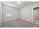 Spacious bedroom with grey carpet and large window at 1717 Forest Run Ln, Auburndale, FL 33823