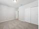 Well-lit bedroom featuring a double door closet and additional access to hallway at 1717 Forest Run Ln, Auburndale, FL 33823