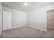 Well-lit bedroom featuring grey carpet and walk-in closet at 1717 Forest Run Ln, Auburndale, FL 33823