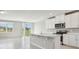 Open concept kitchen with island, stainless steel appliances, and white cabinets at 1717 Forest Run Ln, Auburndale, FL 33823