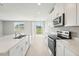 Kitchen with white cabinets, stainless steel appliances, and a large island at 1717 Forest Run Ln, Auburndale, FL 33823