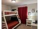 bedroom with bunk beds and red accents at 5299 Wildwood Way, Davenport, FL 33837