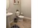Clean bathroom with pedestal sink and toilet at 5299 Wildwood Way, Davenport, FL 33837