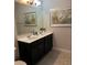 Modern bathroom with a double vanity and dark cabinets at 5299 Wildwood Way, Davenport, FL 33837