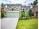 Two-story house with green exterior and landscaping at 5299 Wildwood Way, Davenport, FL 33837