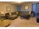 Comfortable Gathering room with sectional sofa and ottoman at 5299 Wildwood Way, Davenport, FL 33837