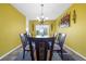 Bright dining room with a glass-top table and six chairs at 1233 Nelson Park Court, Poinciana, FL 34759