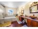 Elegant bathroom featuring a soaking tub and double vanity at 1233 Nelson Park Court, Poinciana, FL 34759