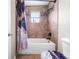 Clean bathroom with a shower/tub combo and updated tile at 1233 Nelson Park Court, Poinciana, FL 34759