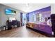 Spacious bedroom with city-themed wall mural and wood-look floors at 1233 Nelson Park Court, Poinciana, FL 34759