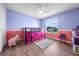 Bright bedroom with large window and wood-look floors at 1233 Nelson Park Court, Poinciana, FL 34759