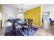 Bright dining room with a glass-top table and six chairs at 1233 Nelson Park Court, Poinciana, FL 34759