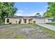 House exterior featuring solar panels and a one-car garage at 832 Valnera Ct, Kissimmee, FL 34758