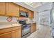 Kitchen with light wood cabinets, black appliances, and ample counter space at 832 Valnera Ct, Kissimmee, FL 34758