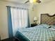 Spacious bedroom with teal bedding and ensuite bath at 306 Athabasca Pl, Kissimmee, FL 34759