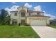 Two-story house with a large yard and two-car garage at 306 Athabasca Pl, Kissimmee, FL 34759