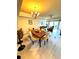 Open concept dining area with hardwood floors and chandelier at 7652 Whisper Way # 302, Reunion, FL 34747