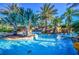 Resort-style pool with lush landscaping at 7652 Whisper Way # 302, Reunion, FL 34747