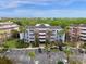 Aerial view of building, parking lot, and landscaping at 7652 Whisper Way # 302, Reunion, FL 34747
