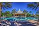 Community pool with clubhouse in background at 7652 Whisper Way # 302, Reunion, FL 34747