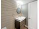Contemporary half-bathroom with floating vanity and round mirror at 360 Golfside Cv # 360, Longwood, FL 32779
