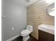 Stylish bathroom with modern vanity and wood-paneled walls at 360 Golfside Cv # 360, Longwood, FL 32779