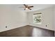 Bright bedroom with dark laminate floors and a large window at 721 Sailfish Rd, Winter Springs, FL 32708