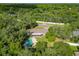 High-angle view of the house and surrounding lush greenery, highlighting its private location at 601 Marlin Rd, Winter Springs, FL 32708
