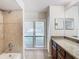 Bathroom with granite countertop, large mirror, and tiled shower at 601 Marlin Rd, Winter Springs, FL 32708