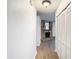 Hallway with white walls, wood-look floors and built-in storage at 601 Marlin Rd, Winter Springs, FL 32708