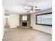 Living room with a stone fireplace and wood-look floors at 601 Marlin Rd, Winter Springs, FL 32708