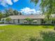 Single-story home with gray siding, a spacious lawn, and mature trees at 601 Marlin Rd, Winter Springs, FL 32708