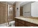 Clean bathroom with shower, granite vanity and large mirror at 8300 Ludington Cir, Orlando, FL 32836