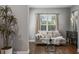 Cozy living room with comfy couch, glass coffee table, and large windows at 8300 Ludington Cir, Orlando, FL 32836